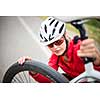 Pretty, young female biker outdoors on her mountain bike (shallow DOF; selective focus)