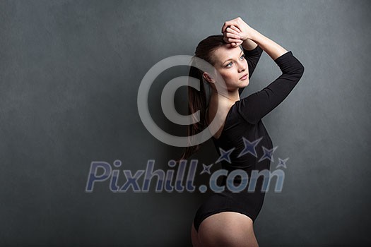 Beautiful, young woman in front of a grey background Beautiful, young woman in front of a grey background