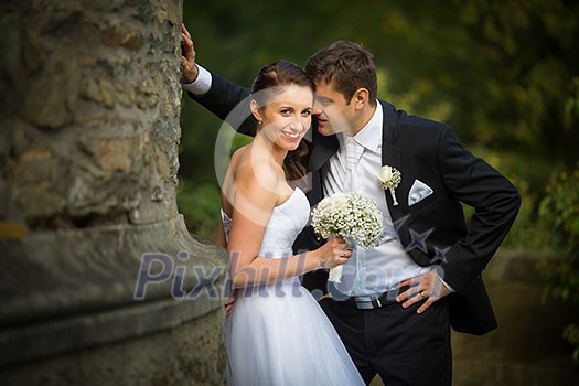 Beautiful, happy, younf wedding couple in a splendid historic castle environment, walking up the stairs, shining with happiness Beautiful, happy, younf wedding couple in a splendid historic castle environment, walking up the stairs, shining with happiness