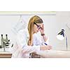 Portrait of a female researcher doing research in a chemistry lab (shallow DOF; color toned image)