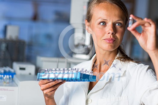 Portrait of a female researcher doing research in a lab (shallow DOF; color toned image)