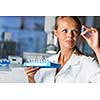 Portrait of a female researcher doing research in a lab (shallow DOF; color toned image)