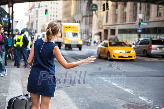Girl calling/hailking taxi cab on Manhattan, New York City, USA