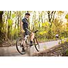 Senior man on his mountain bike outdoors (shallow DOF; color toned image)