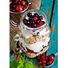 Healthy breakfast with Homemade granola. Muesli, fresh berries and yogurt in glass mason jar on wooden table. 