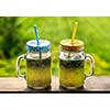Summer drink lemonade with lemon and mint in mason jar outdoor.