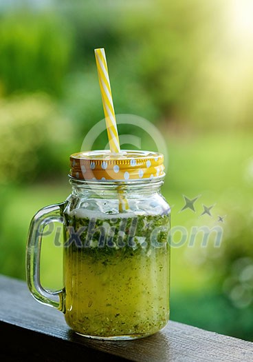 Summer drink lemonade with lemon and mint in mason jar outdoor. Summer drink lemonade with lemon and mint in mason jar outdoor.