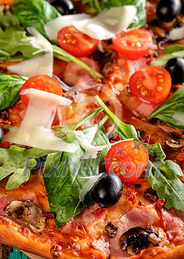 CLose-up of Homemade delicious pizza with bacon, tomatoes, olives and basil CLose-up of Homemade delicious pizza with bacon, tomatoes, olives and basil
