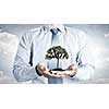 Close up of businessman holding in hands green tree concept