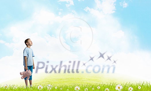 Cute little boy with toy bear on cloud background Cute little boy with toy bear on cloud background