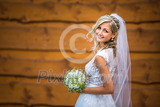 Gorgeous bride on her wedding day holding her lovely bouquet (color toned image; shallow DOF) Gorgeous bride on her wedding day holding her lovely bouquet (color toned image; shallow DOF)