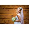 Gorgeous bride on her wedding day  holding her lovely bouquet (color toned image; shallow DOF)