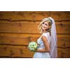 Gorgeous bride on her wedding day  holding her lovely bouquet (color toned image; shallow DOF)