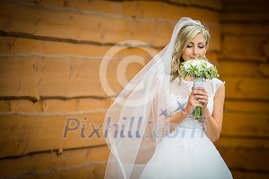 Gorgeous bride on her wedding day holding her lovely bouquet (color toned image; shallow DOF) Gorgeous bride on her wedding day holding her lovely bouquet (color toned image; shallow DOF)
