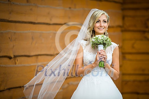 Gorgeous bride on her wedding day  holding her lovely bouquet (color toned image; shallow DOF)