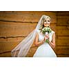 Gorgeous bride on her wedding day  holding her lovely bouquet (color toned image; shallow DOF)