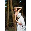 Lovely bride on her wedding day outdoors in a forest (color toned image; shallow DOF)