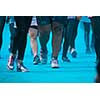 People participating in the Color Run - Runners' legs amid blue powder