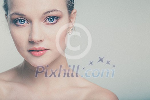 Beautiful young woman with perfect skin and face (color toned image with added grain)