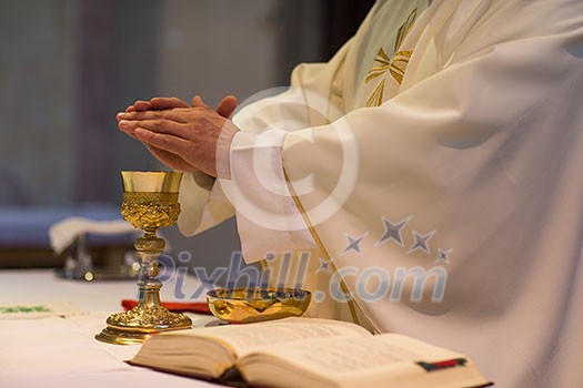 Priest during a wedding ceremony/nuptial mass Priest during a wedding ceremony/nuptial mass