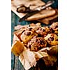 Homemade Tasty Chocolate muffins on the wooden table, rustic style.