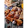 Chocolate muffins with powdered sugar on the wooden table, rustic style. New Year's Concept.