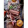 Grilled steak sliced on a cutting board. Entrecote with vegetables on a wooden background. 