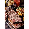 Grilled steak sliced on a cutting board. Entrecote with vegetables on a wooden background. 