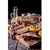 Piece grilled steak on a fork. Grilled steak sliced on a cutting board. Entrecote with vegetables on a wooden background. 