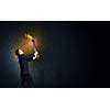 Young businessman holding burning torch in hand