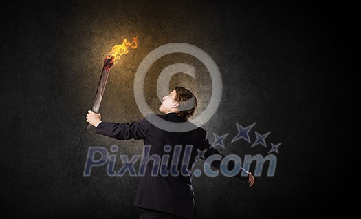 Young businessman holding burning torch in hand