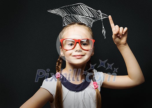 Genius girl in red glasses near blackboard in master hat Genius girl in red glasses near blackboard in master hat