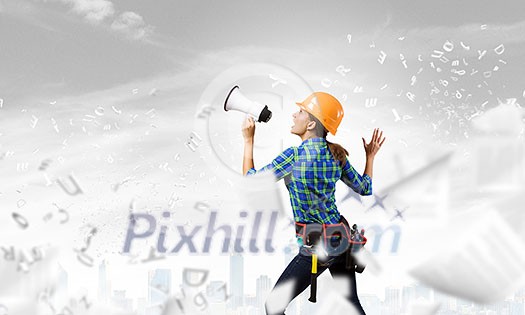 Young woman builder screaming emotionally in megaphone Young woman builder screaming emotionally in megaphone