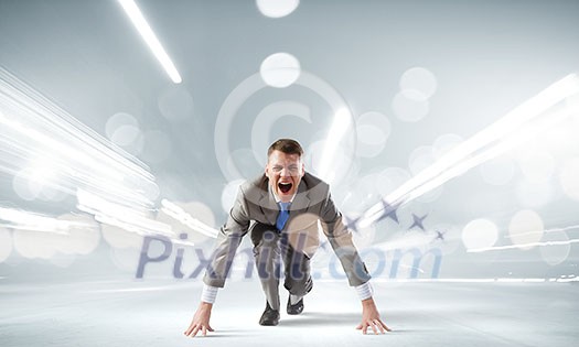 Young determined businessman standing in start position