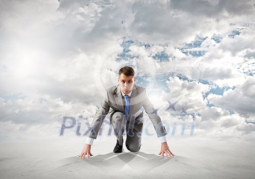 Young determined businessman standing in start position Young determined businessman standing in start position
