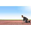 Side view of young businessman in start position on track