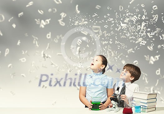Cute girl and boy at chemistry lesson making tests Cute girl and boy at chemistry lesson making tests