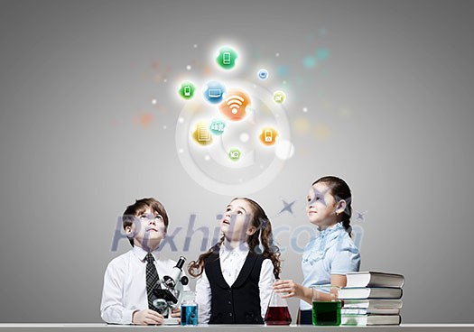 Cute girl and boy at chemistry lesson making tests Cute girl and boy at chemistry lesson making tests
