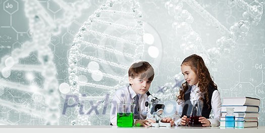 Cute girl and boy at chemistry lesson making tests Cute girl and boy at chemistry lesson making tests