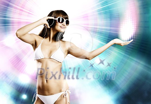 Young attractive girl in white bikini and headphones Young attractive girl in white bikini and headphones