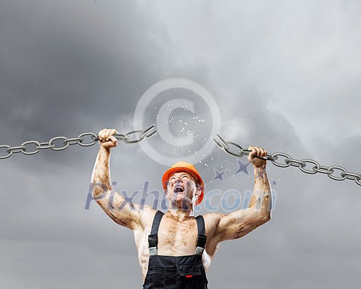 Strong man in uniform tearing metal chain with hands