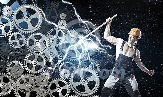 Strong man mechanic in uniform with spanner fixing mechanism Strong man mechanic in uniform with spanner fixing mechanism