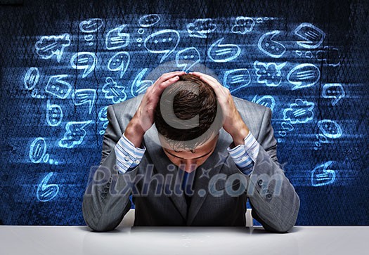 Troubled young businessman covering head with hands Troubled young businessman covering head with hands