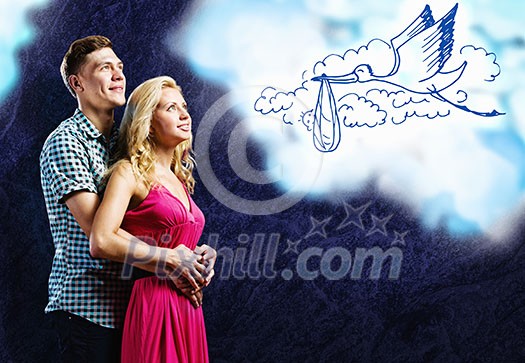 Young happy couple dreaming about future children Young happy couple dreaming about future children