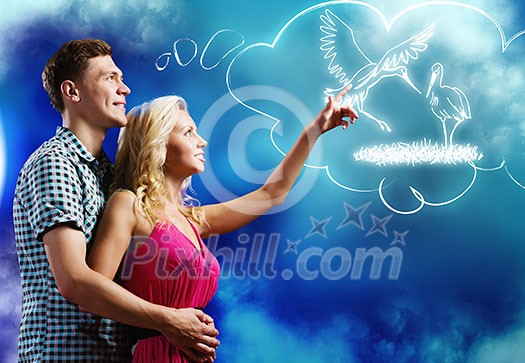 Young happy couple dreaming about future children