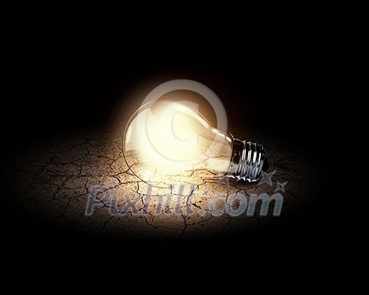 Conceptual image of light bulb on desert surface Conceptual image of light bulb on desert surface