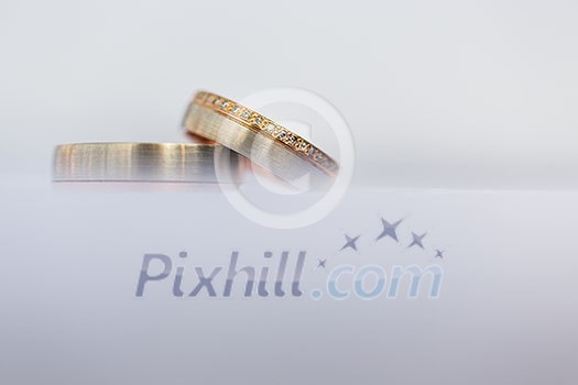 Wedding day details - two lovely golden wedding rings awaiting their moment (shallow DOF; color toned image) Wedding day details - two lovely golden wedding rings awaiting their moment (shallow DOF; color toned image)