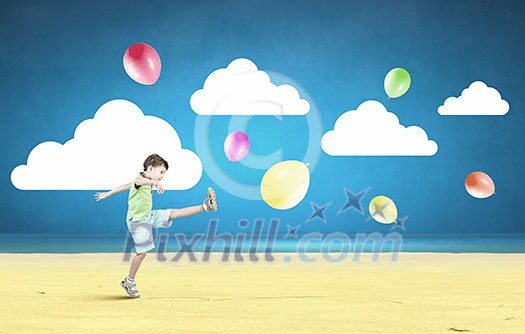 Little cute boy playing joyfully with colorful balloon Little cute boy playing joyfully with colorful balloon
