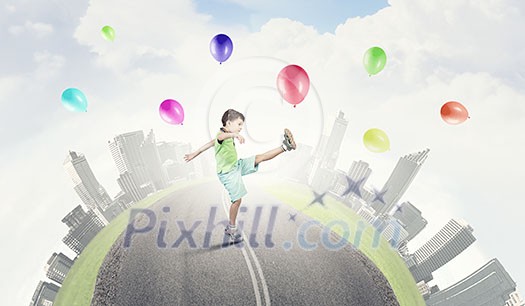 Little cute boy playing joyfully with colorful balloon Little cute boy playing joyfully with colorful balloon