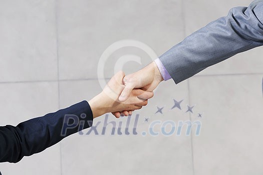 Close up of business handshake between two colleagues Close up of business handshake between two colleagues